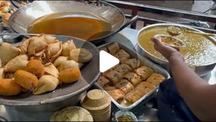 A frame from The Ram Bhandar's official Reel — jalebi frying in the kadhai beside baskets of kachori and sabzi trays